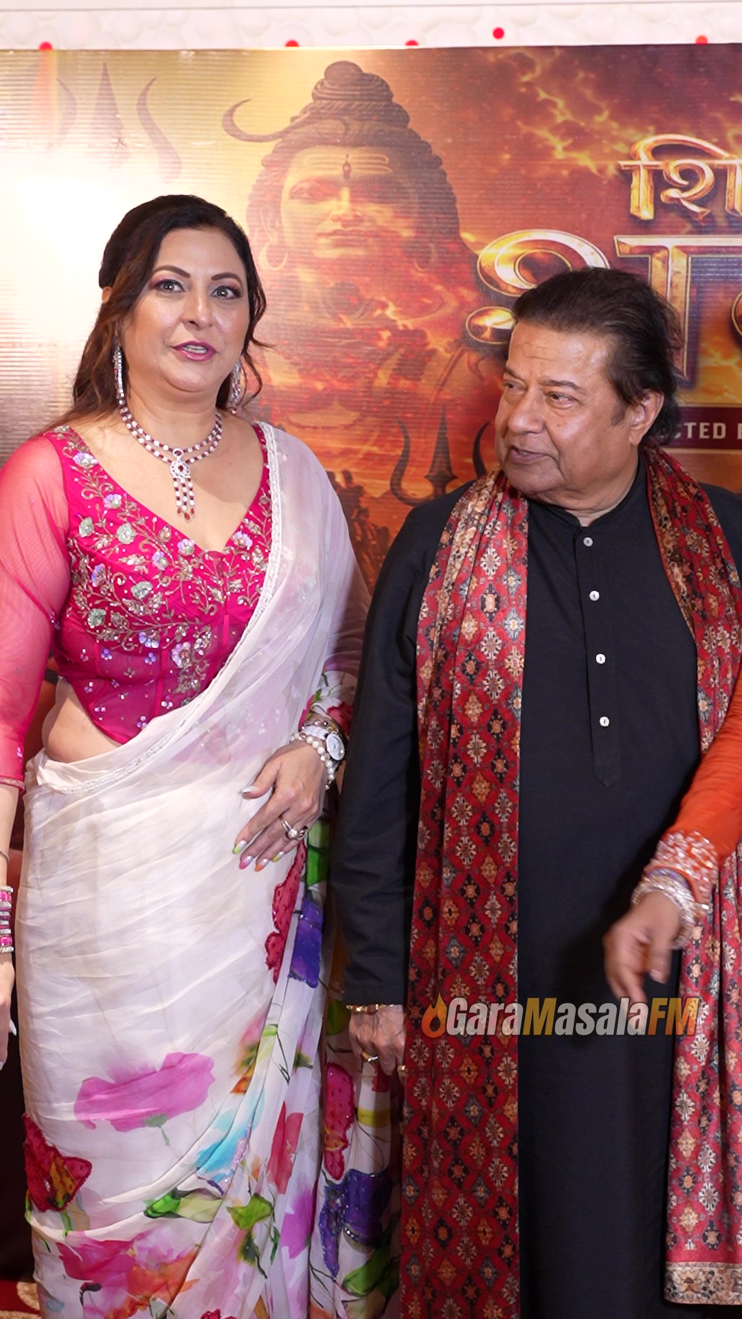 Anup Jalota stops for the shutter wall at a paparazzi photo call.