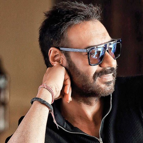 Ajay Devgn at a film event, looking serious.